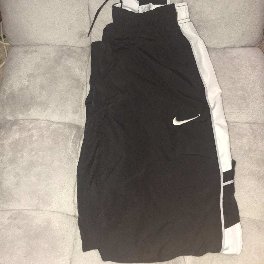 Nike boys black wind pants.